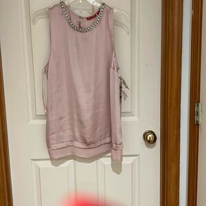 Very dressy rose colored sleeveless top. Detailed rhinestone and pearl neckline